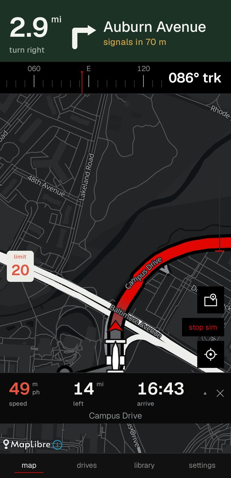 the driving screen: the instruction band reading the distance to the next turn and the road it joins, a speed limit plate on the map, and the trip figures along the bottom